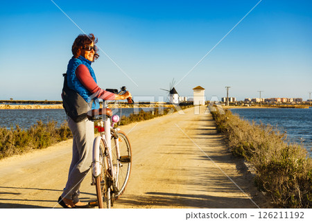 Woman with bike at San Pedro del Pinatar park, Spain 126211192