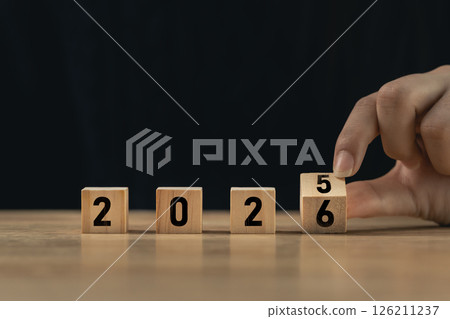 Creative concept of changing the year from 2025 to 2026 using wooden blocks with numbers, symbolizing time transition and new beginnings 126211237