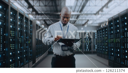 Big Data Center with Server Racks: Specialist Using Tablet Computer, Activating Servers Big Data Center with Server Racks: Specialist Using Tablet Computer, Activating Servers 126211374