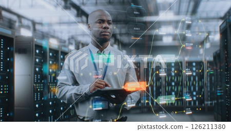 Futuristic Big Data Center with VFX: Administrator Using Digital Tablet 126211380