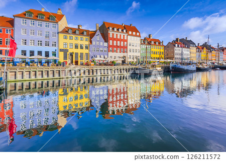 Copenhagen, Denmark. Nyhavn Canal is a vibrant harbor lined with colorful buildings and boats. 126211572