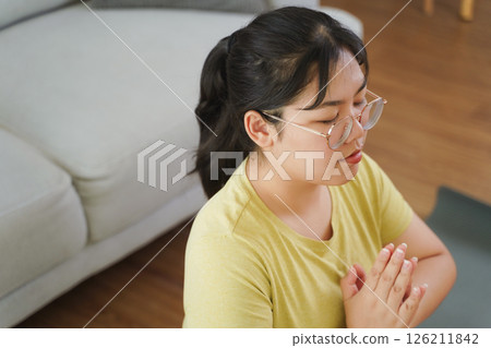 Asian woman meditate and practice yoga in the living room at home, home health care Asian woman meditate and practice yoga in the living room at home, home health care 126211842