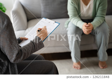Psychologist doctor examine and listen and talking to patient with depression, anxiety Psychologist doctor examine and listen and talking to patient with depression, anxiety 126211848