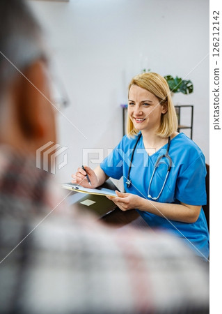Doctor joyfully consults with patient 126212142