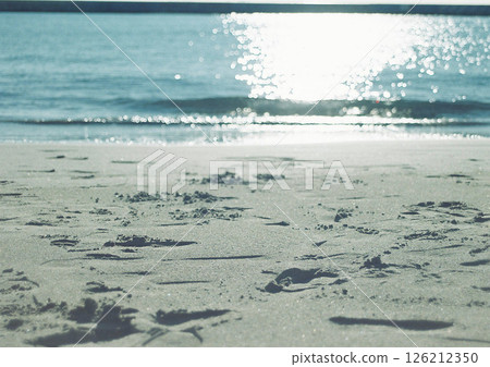 Waves and soap bubbles crashing on a sandy beach, photographed with a film camera Waves and soap bubbles crashing on a sandy beach, photographed with a film camera 126212350
