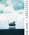 Drink in a glass photographed with a film camera 126212353