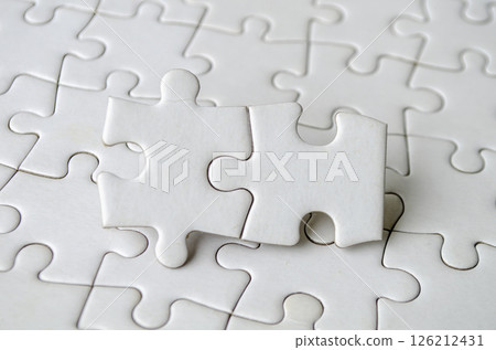 Close up of jigsaw puzzle pieces with customizable space on jigsaw for text or ideas Close up of jigsaw puzzle pieces with customizable space on jigsaw for text or ideas 126212431