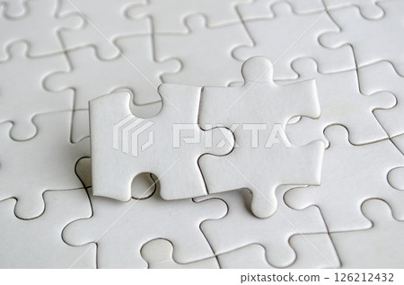 Close up of jigsaw puzzle pieces with customizable space on jigsaw for text or ideas. 126212432