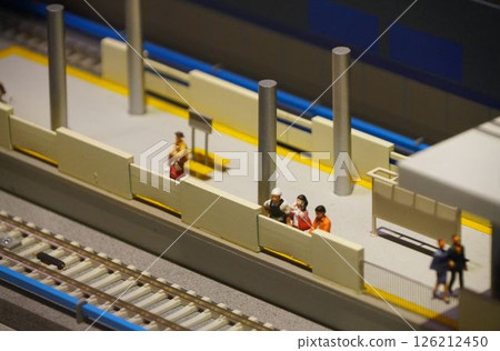 Miniature people waiting on a station platform 126212450