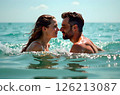 Smiling couple enjoying time together swimming in sea 126213087