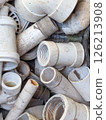 Messy pile of white PVC plumbing fittings and pipes discarded after use Messy pile of white PVC plumbing fittings and pipes discarded after use 126213908