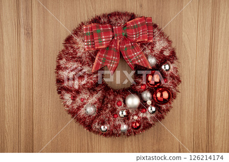 Winter Christmas wreath on the door with twinkling lights. Winter Christmas wreath on the door with twinkling lights. 126214174