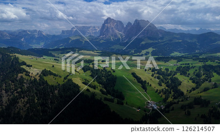 Expansive green valleys and towering mountains capture the breathtaking beauty of the Dolomites in summer Expansive green valleys and towering mountains capture the breathtaking beauty of the Dolomites in summer 126214507