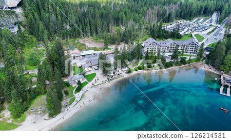 Scenic lakeside resort nestled among towering trees in a tranquil setting on a sunny day 126214581