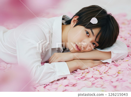 A young Japanese man with a gentle gaze surrounded by flower petals (AI-generated image) 126215043
