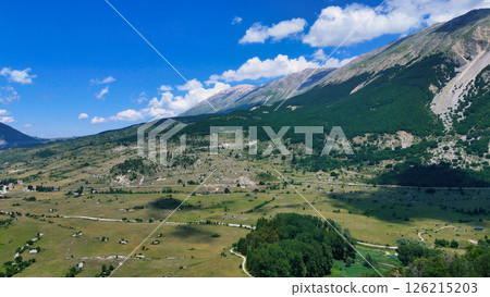 Breathtaking mountain landscape under a vast blue sky showcasing the majesty of nature's untouched beauty at midday Generative AI 126215203