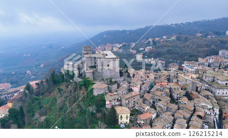 Exploring a historic fortress overlooking a charming hillside village in the Italian countryside on a misty day Generative AI 126215214