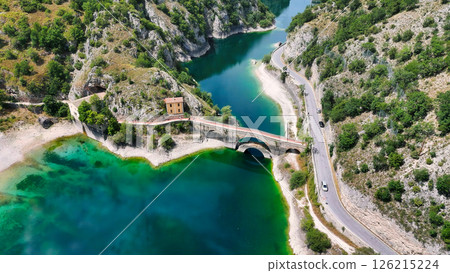 Serene waterscapes enhance the beauty of an ancient bridge surrounded by lush hills during a sunny afternoon Generative AI Serene waterscapes enhance the beauty of an ancient bridge surrounded by lush hills during a sunny afternoon Generative AI 126215224