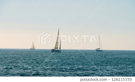 Sailboats gliding peacefully across the serene water during a warm afternoon in the coastal horizon Generative AI Sailboats gliding peacefully across the serene water during a warm afternoon in the coastal horizon Generative AI 126215350