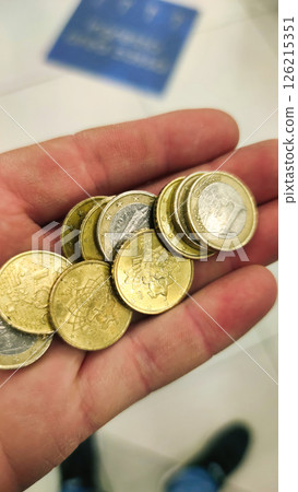 Hand holds various coins showcasing diverse currencies in a busy public space on a bright afternoon Generative AI Hand holds various coins showcasing diverse currencies in a busy public space on a bright afternoon Generative AI 126215351