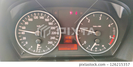 Speed and time displayed on a vehicle dashboard at noon, showcasing the journey progress and outdoor temperature Generative AI Speed and time displayed on a vehicle dashboard at noon, showcasing the journey progress and outdoor temperature Generative AI 126215357