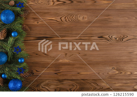 christmas wooden background with fir branches and cones and blue ornaments christmas wooden background with fir branches and cones and blue ornaments 126215590