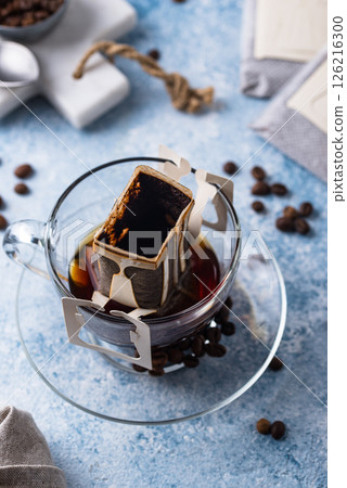Freshly brewed drip coffee in glass cup 126216300