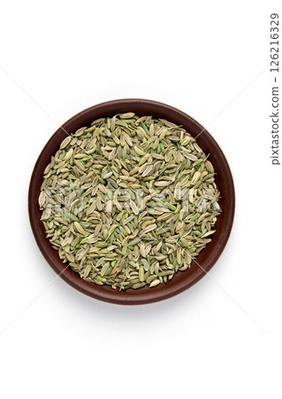 dried fennel seeds in brown clay bowl isolated on white background. top view with copy space 126216329
