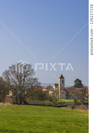 Chapaize in Saone et Loire, Bourgogne Franche Comte, France, showing its church and surrounding countryside landscape 126217158