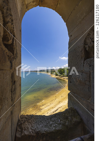 Embrasure in the medieval bridge of Las Rozas de Valdearroyo overlooking Ebro reservoir in Cantabria, Spain Embrasure in the medieval bridge of Las Rozas de Valdearroyo overlooking Ebro reservoir in Cantabria, Spain 126217180