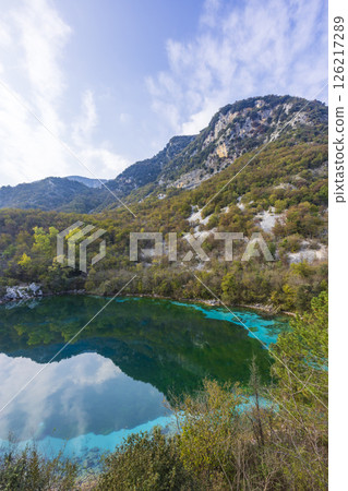 Cornino Lake reflecting clouds and mountains in Forgaria nel Friuli, Italy Cornino Lake reflecting clouds and mountains in Forgaria nel Friuli, Italy 126217289