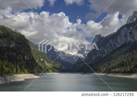 Gosaulack reflecting Dachstein Mountains under cloudy sky in Upper Austria 126217298