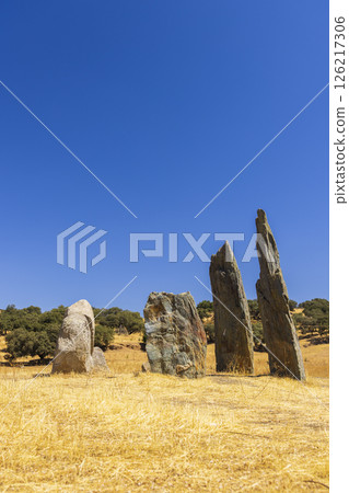 Dolmen of the Toriillo del Cura in Rosal de la Frontera, Spain, standing tall under blue sky 126217306