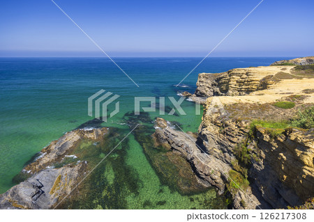 Breathtaking coastal landscape showing cliffs and turquoise waters in Odemira, Portugal Breathtaking coastal landscape showing cliffs and turquoise waters in Odemira, Portugal 126217308