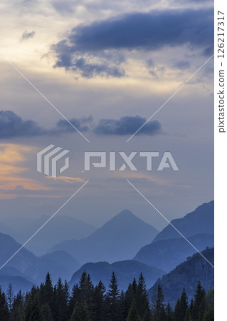 Stunning sunset illuminating blue mountains in Chiusaforte, Italy Stunning sunset illuminating blue mountains in Chiusaforte, Italy 126217317