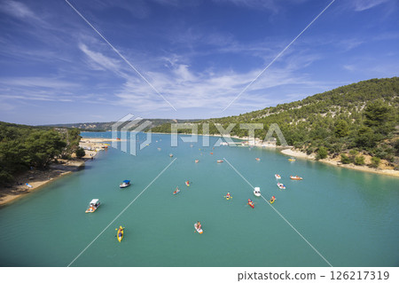 Tourists enjoying turquoise water of Lac de Sainte Croix in Verdon Gorge, Provence, France Tourists enjoying turquoise water of Lac de Sainte Croix in Verdon Gorge, Provence, France 126217319