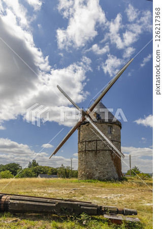 Old windmill standing in La Possonniere, France, under blue sky 126217368