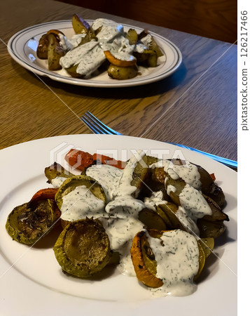 Baked vegetables with sauce on a wooden table 126217466