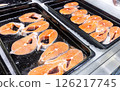 Steaks of fresh salmon fish on the counter. Raw red fish for sale. Seafood shop 126217745