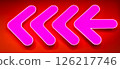 Bright pink neon arrow sign. Glowing neon arrow pointer on the wall of a building 126217746