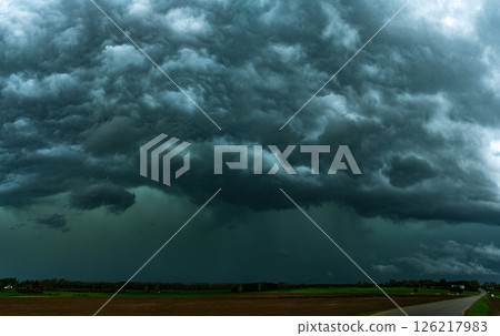 Storm clouds over field, tornadic supercell, extreme weather, dangerous storm, climate change Storm clouds over field, tornadic supercell, extreme weather, dangerous storm, climate change 126217983