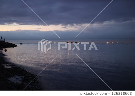 The water is calm and the sky is dark 126218608