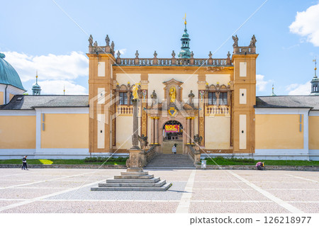 Visitors explore the impressive Baroque complex at Holy Mountain in Pribram, Czechia, a renowned pilgrimage site, showcasing its detailed architecture under a clear blue sky. Visitors explore the impressive Baroque complex at Holy Mountain in Pribram, Czechia, a renowned pilgrimage site, showcasing its detailed architecture under a clear blue sky. 126218977