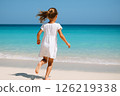 Girl running to the sea 126219338