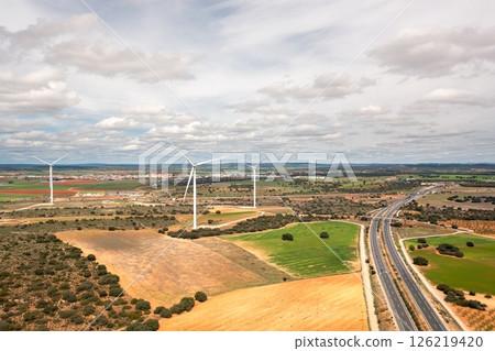 Wind turbines spread across farmland with 126219420