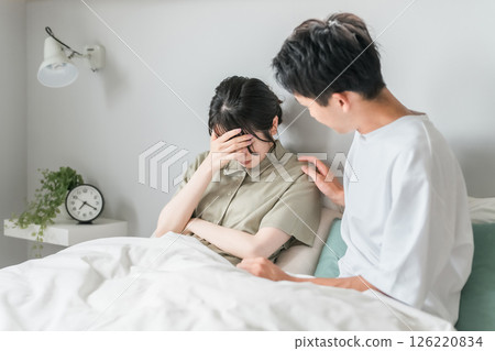 Husband comforting sad wife in bed (comforting, couple quarrel) Husband comforting sad wife in bed (comforting, couple quarrel) 126220834