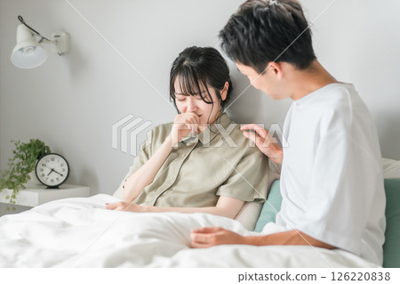 A woman suffering from symptoms of rhinitis, hay fever, and nasal congestion and a worried man A woman suffering from symptoms of rhinitis, hay fever, and nasal congestion and a worried man 126220838