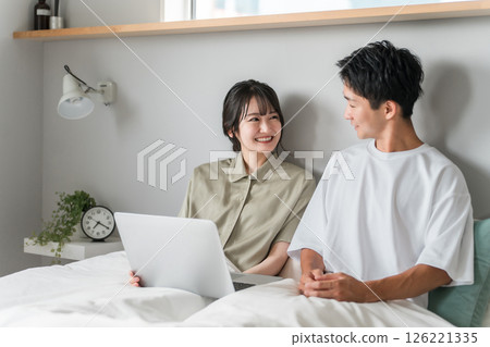 Asian couple, couple, lover, family using a laptop in the bedroom Asian couple, couple, lover, family using a laptop in the bedroom 126221335