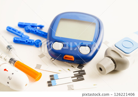 Glucometer lancet and test strips testing blood sugar for diabetes. Glucometer lancet and test strips testing blood sugar for diabetes. 126221406