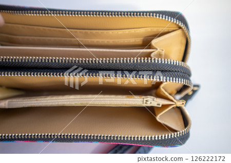 Fashionable outdoor women's empty wallet with gold zippers, top view, on white background 126222172